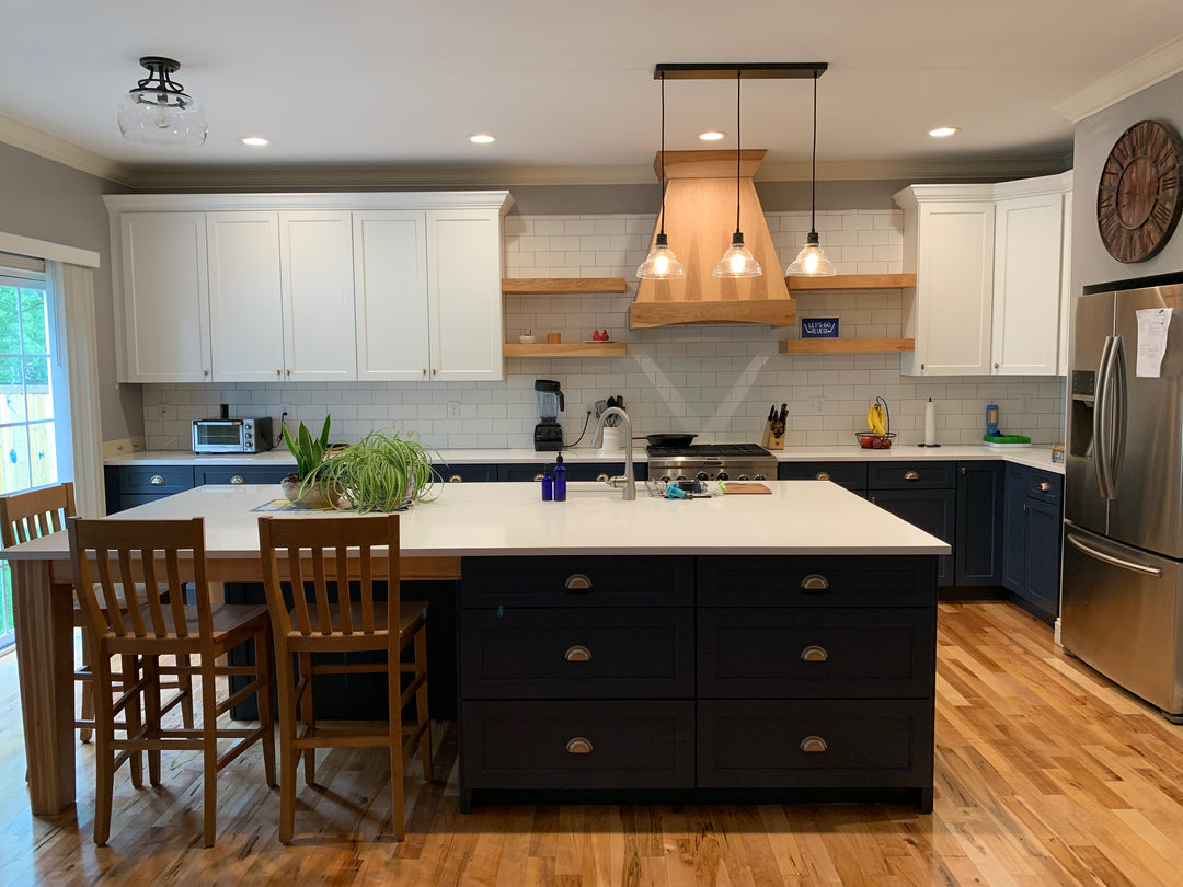 Kitchen in St. Louis with refaced cabinets in white and wood hood. Large island with quartz counter top.