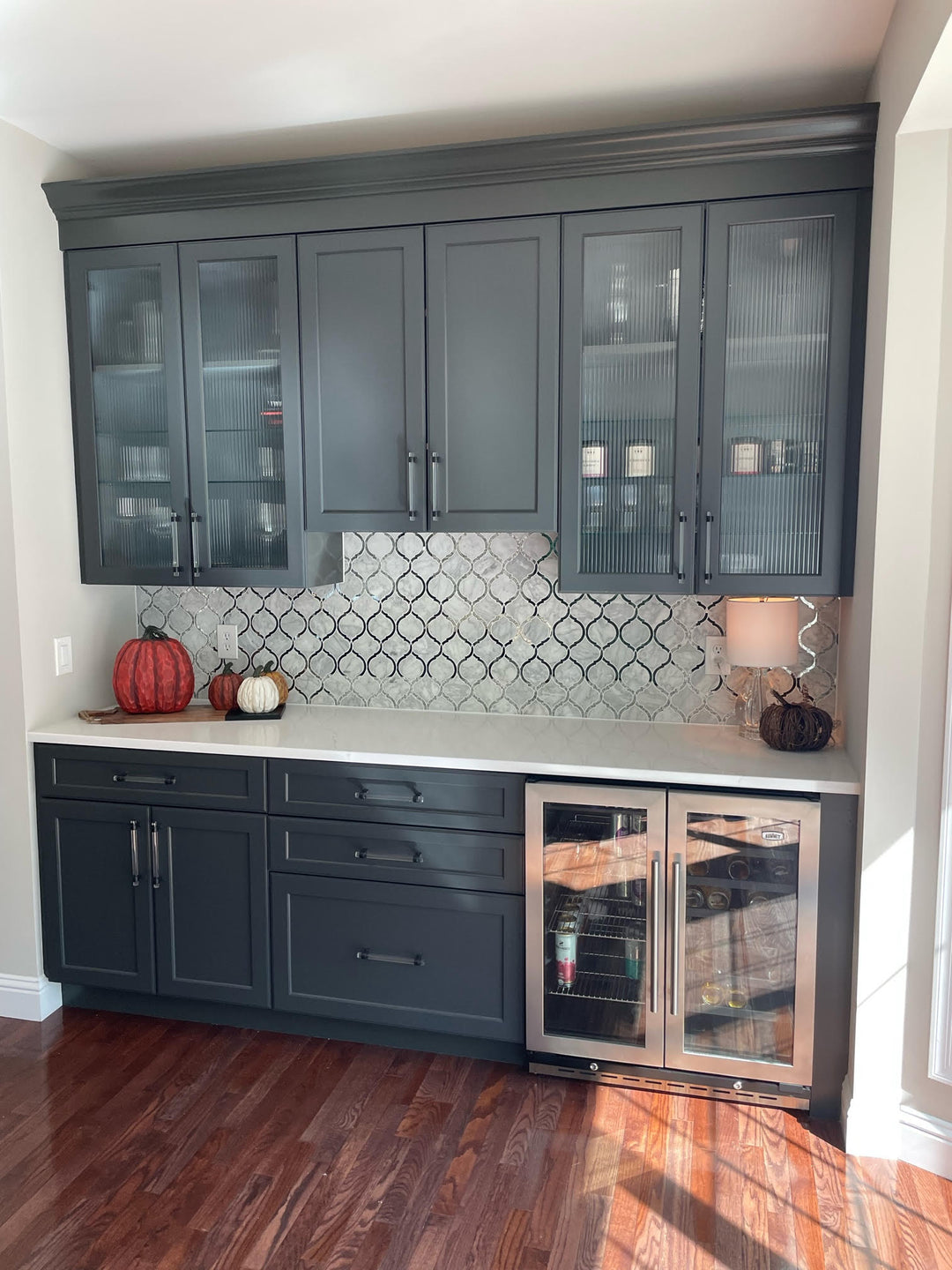 Custom blue painted kitchen with ceramic tile backsplash, fluted glass and wine fridge