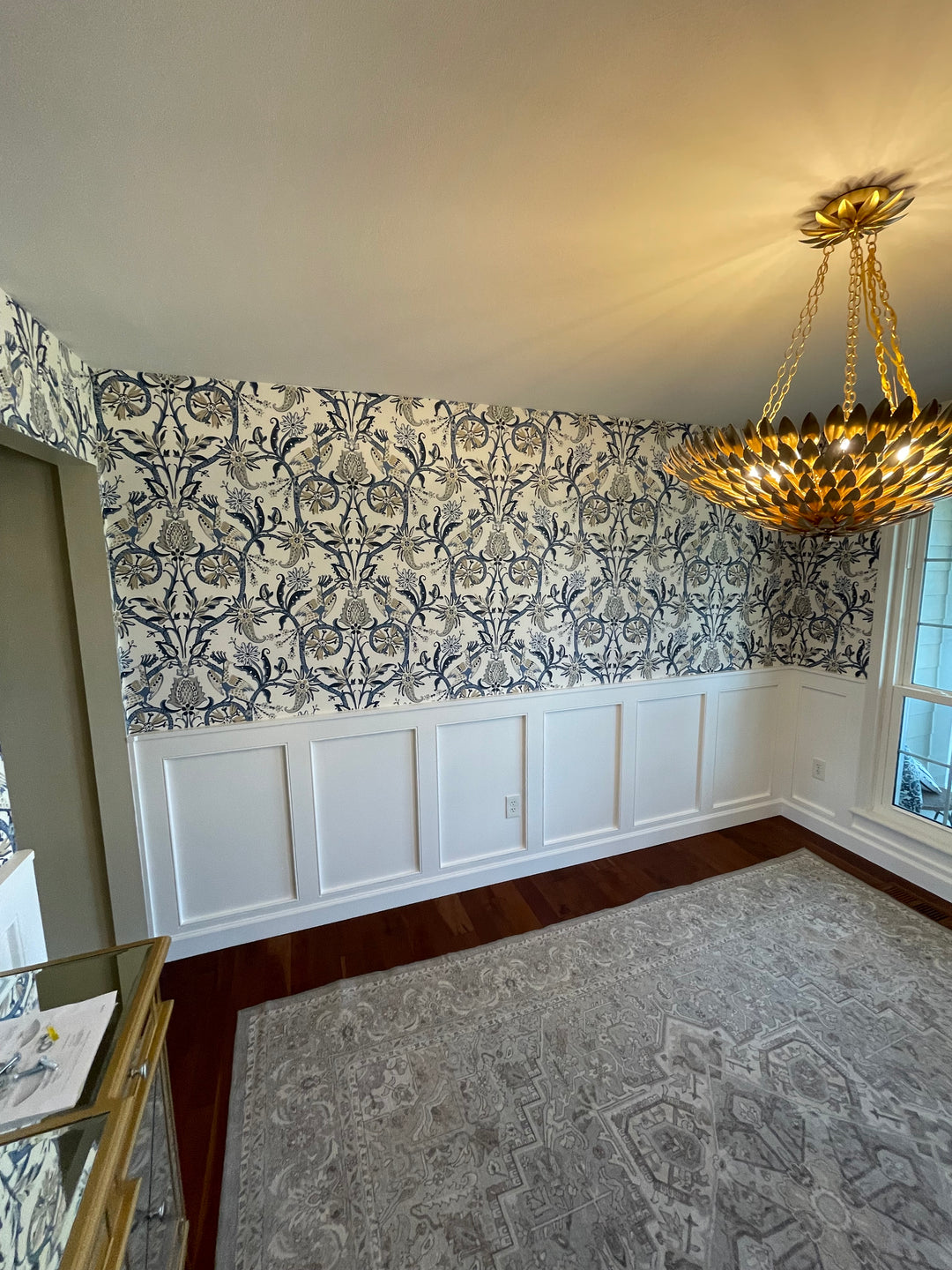 Dinning room with white wainscoting and blue floral wallpaper